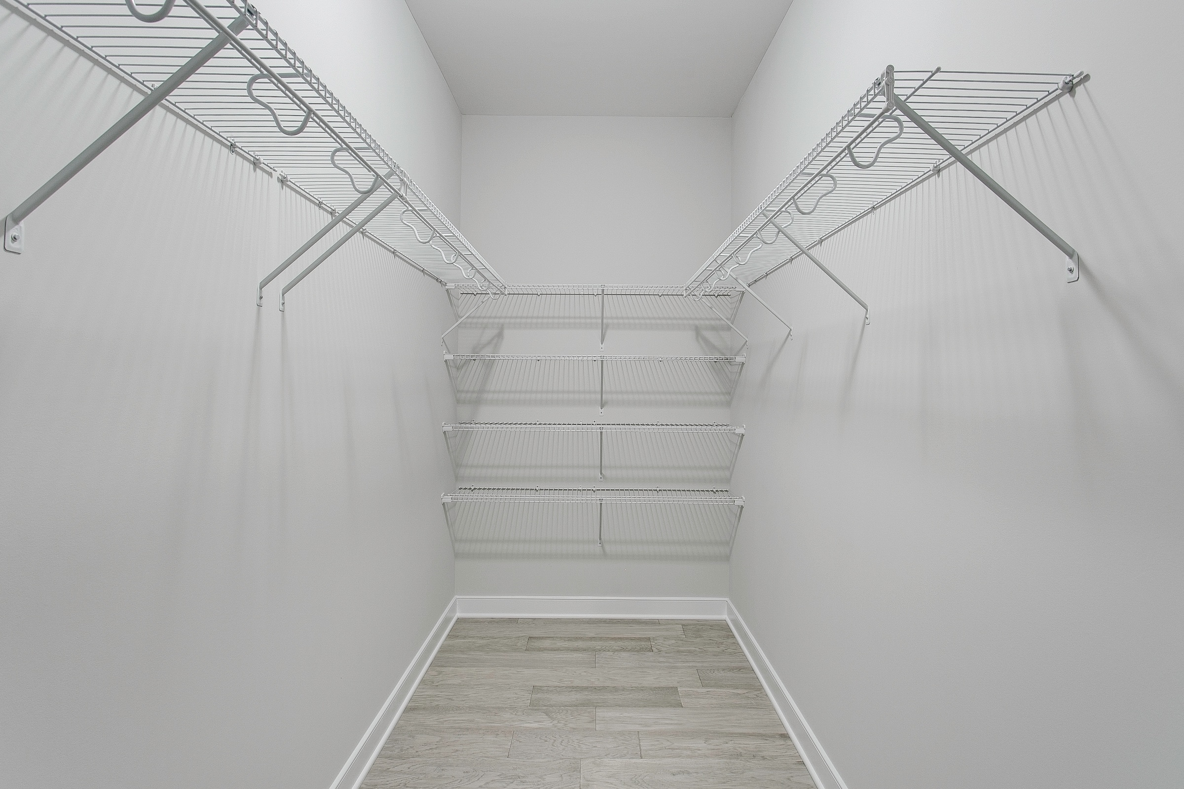 Nice modern white wire shelving in spacious closet